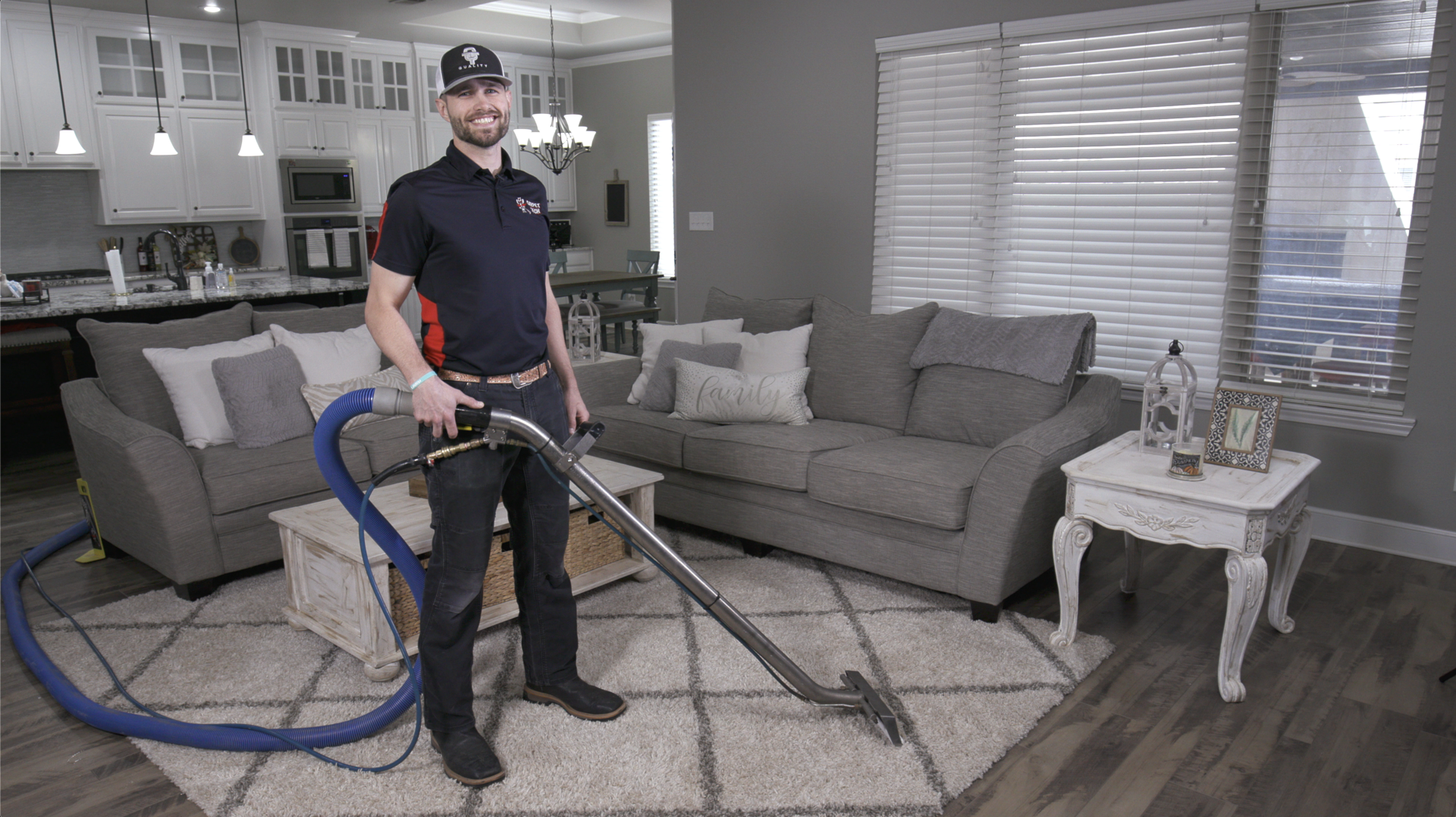 Smiling technician cleaning carpet