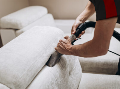 Technician cleaning a couch