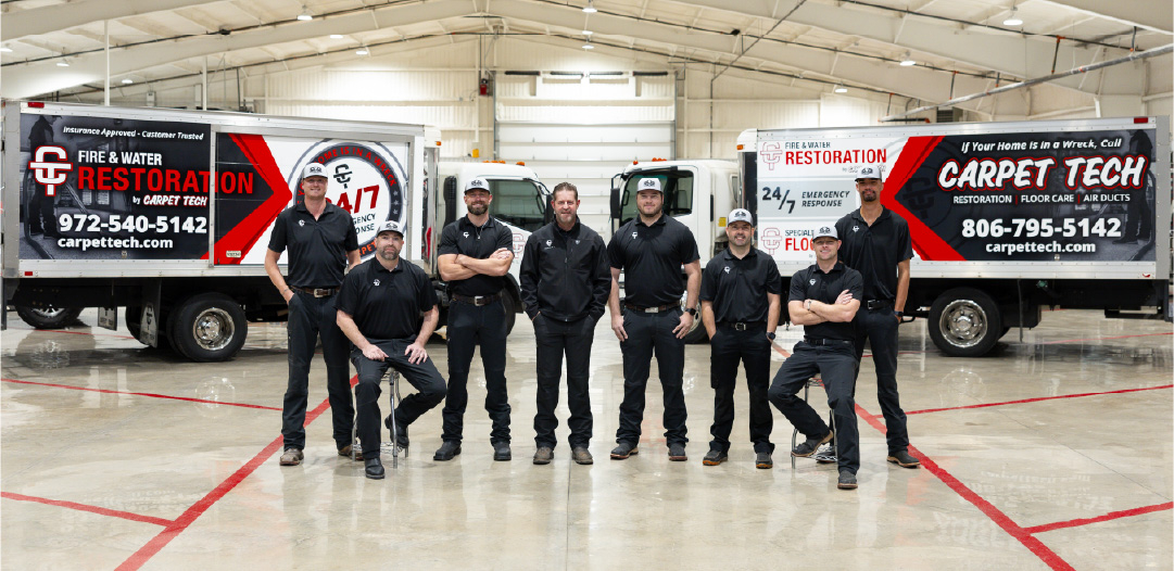 Group of technicians in front of cleaning rigs.