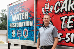 Technician beside restoration truck