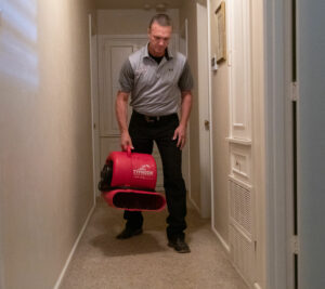 technician with dehumidifier