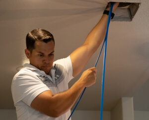 air duct technician inspecting ducts