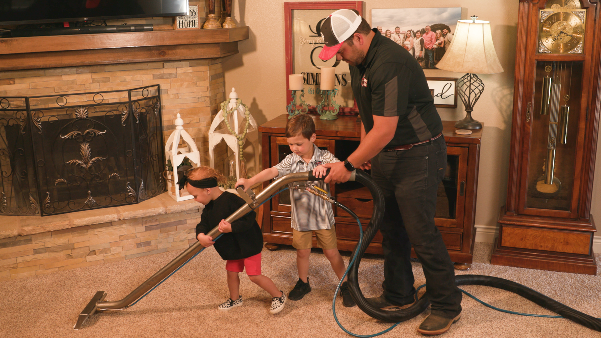 Technician with children cleaning carpet