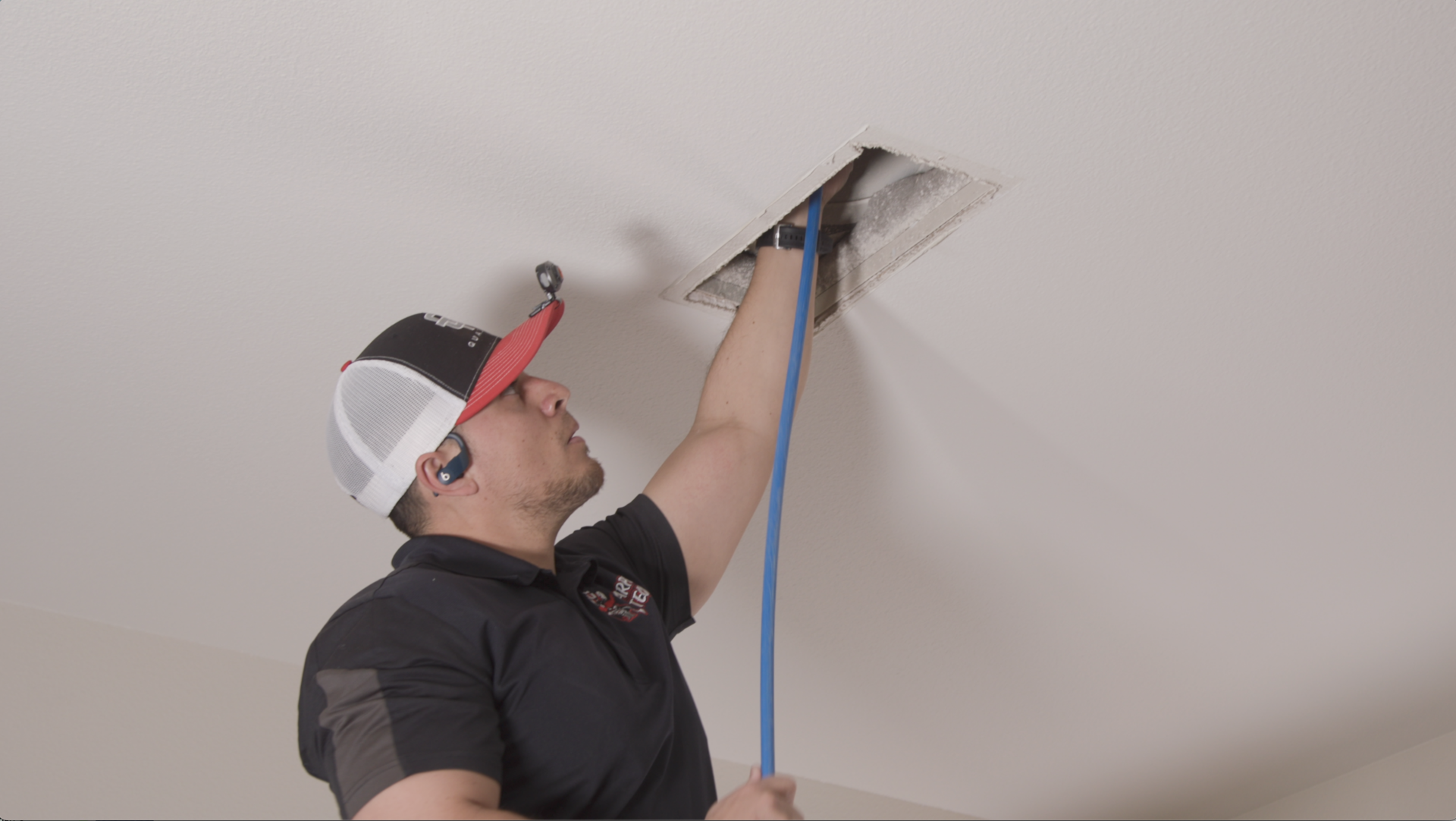 Technician cleaning an air vent.