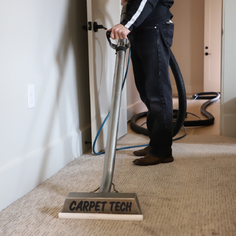 Carpet Tech technician cleaning a carpet.